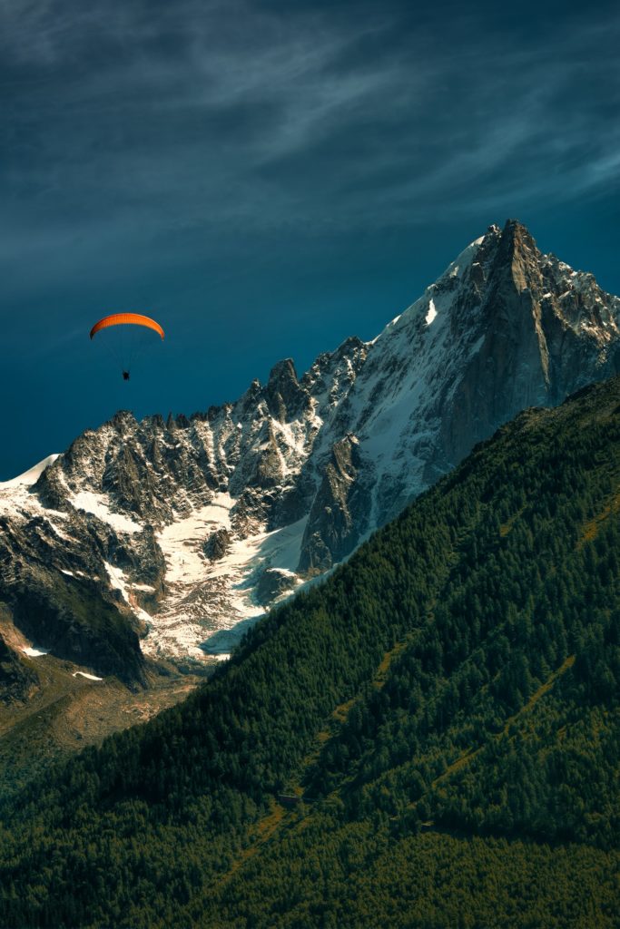 Orange paragliding in the mountains